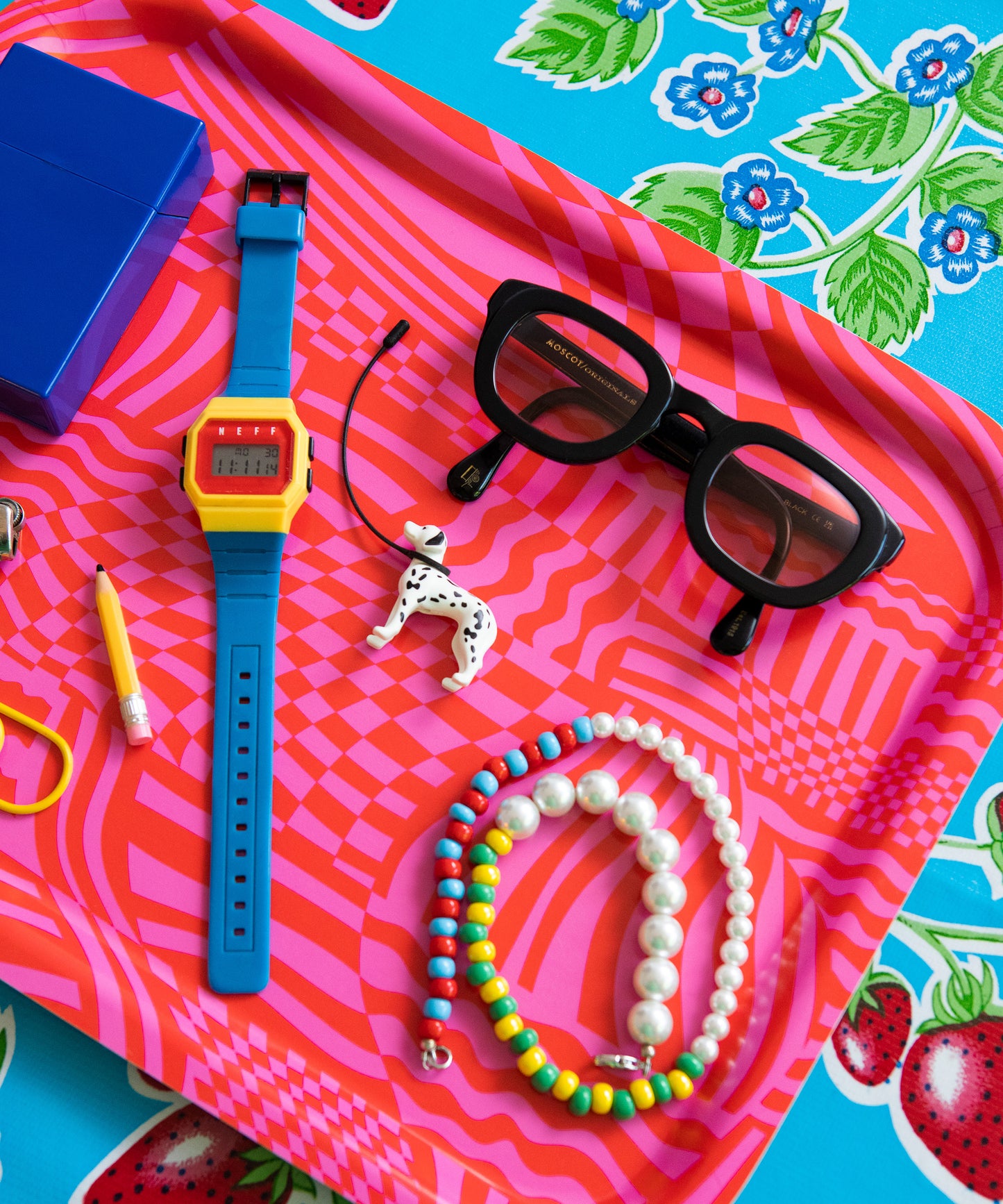 The Wiggles and Waves Tray with a watch, eye glasses, necklace, pencil and a dog accessory sitting on top.