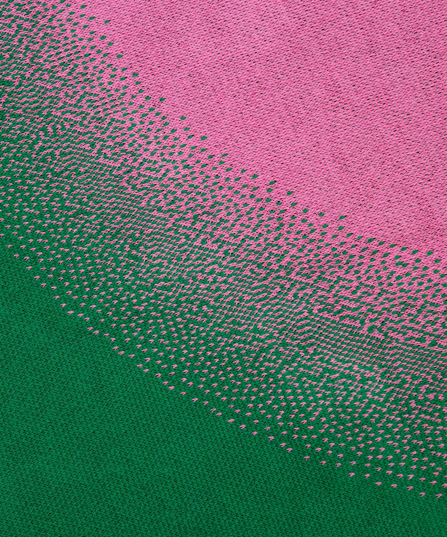 Close up image of Burst Blanket showing the stitching of pink circle going into green background.