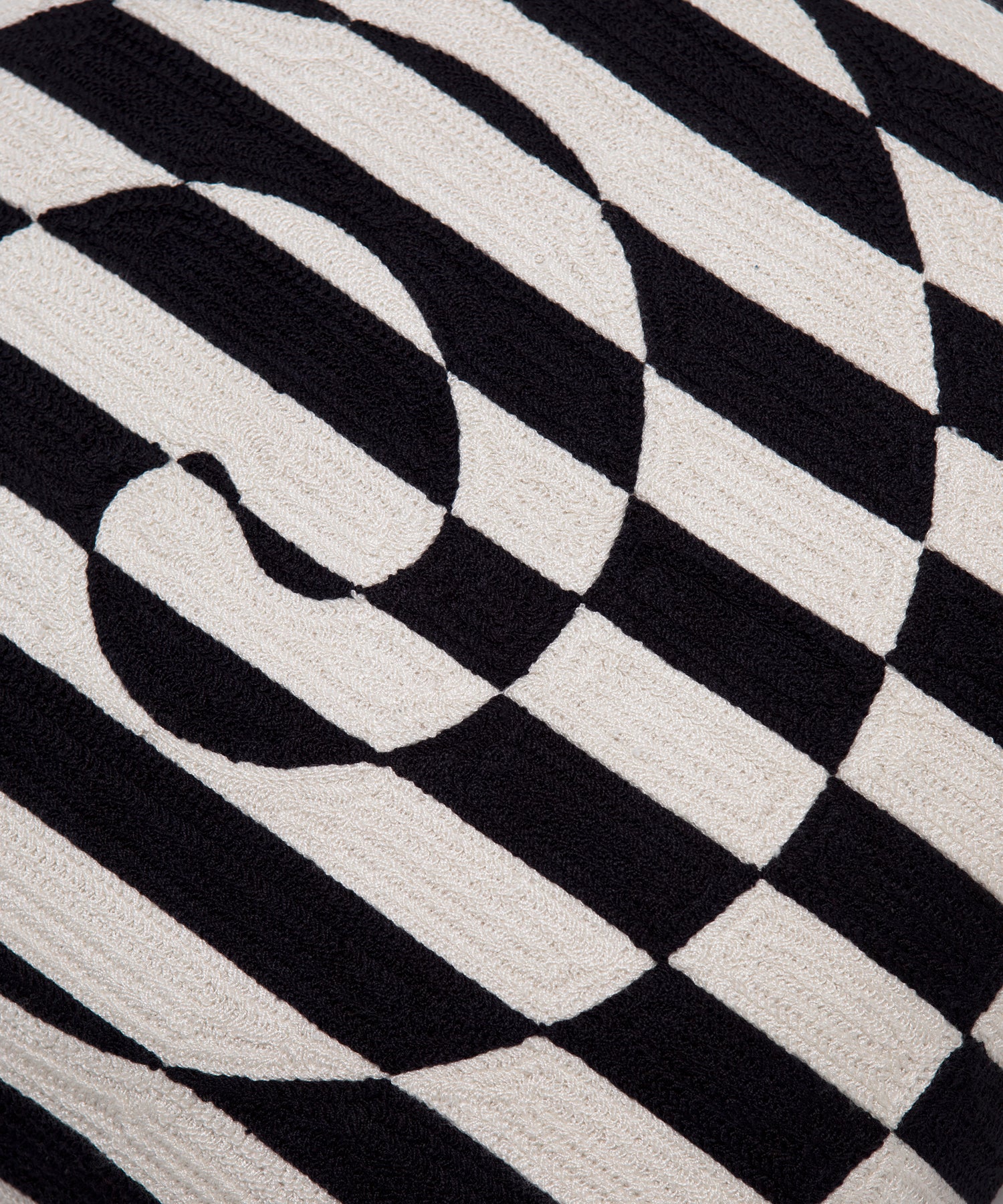 Close up of black and white striped swirl on the Dazzle Pillow Cover. 