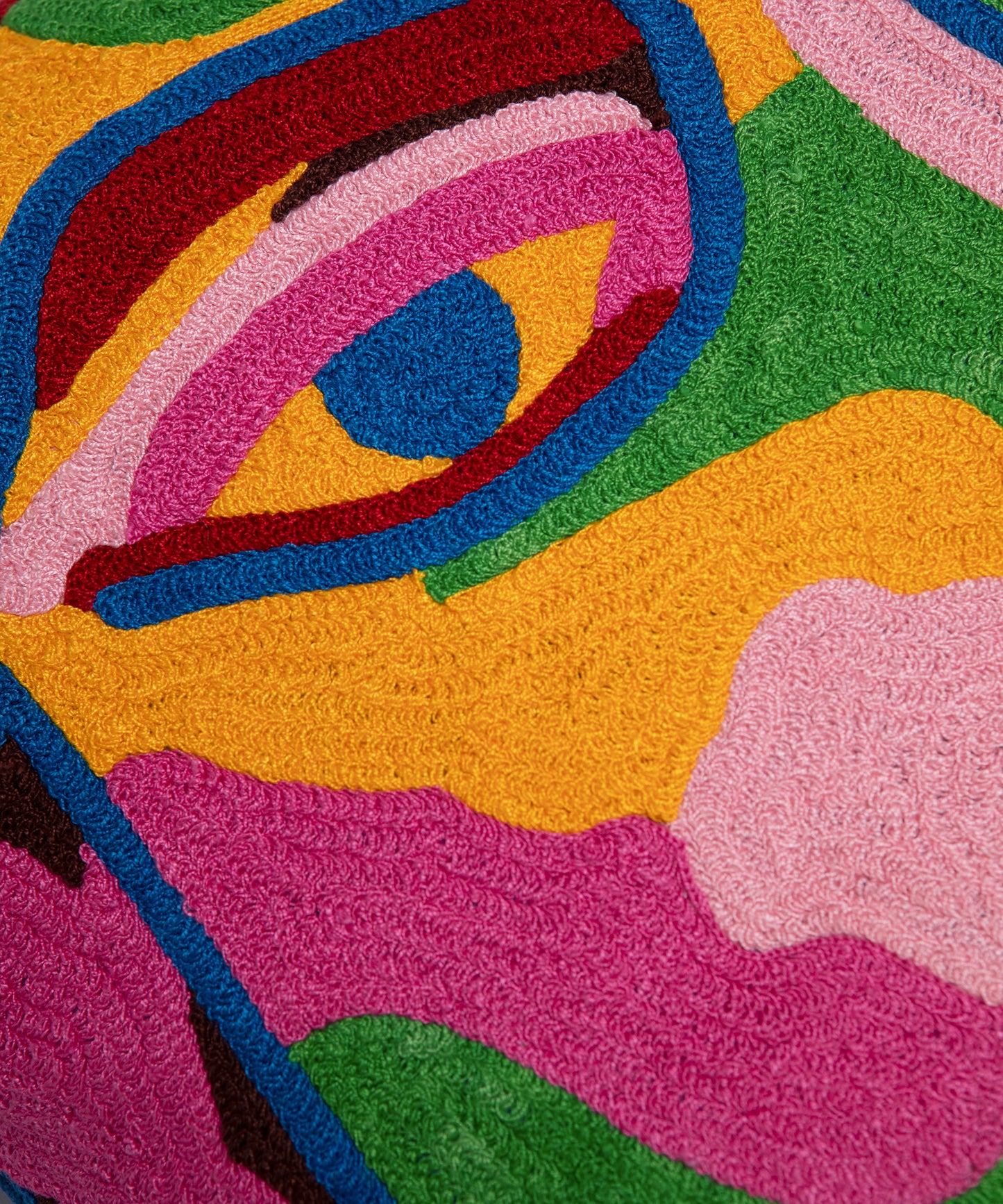 Close up of one of the eyes on the Portrait Pillow Cover showing the multiple colors and stitch pattern.