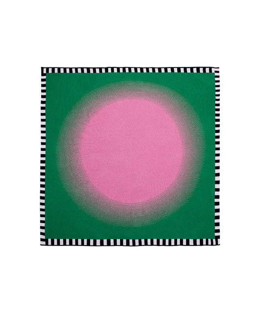 Image of Burst Blanket with a pink circle in center gradually fading into a green background with a black and white stripe border around the entirety of blanket. Knit blanket that is 60" by 60"